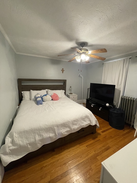 29-31 Bradford Road, Unit 31 Watertown, MA 02472 - Photo 9 of 11 a bedroom with a bed and a television
