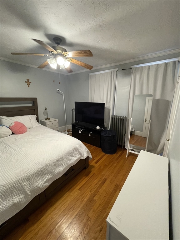 29-31 Bradford Road, Unit 31 Watertown, MA 02472 - Photo 10 of 11 a bedroom with a bed and a mirror