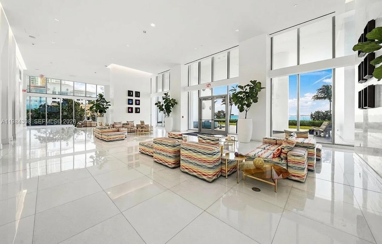700 Northeast 26th Terrace, Unit 5006 Miami, FL 33137 - Photo 14 of 18 a living room with patio furniture and a potted plant