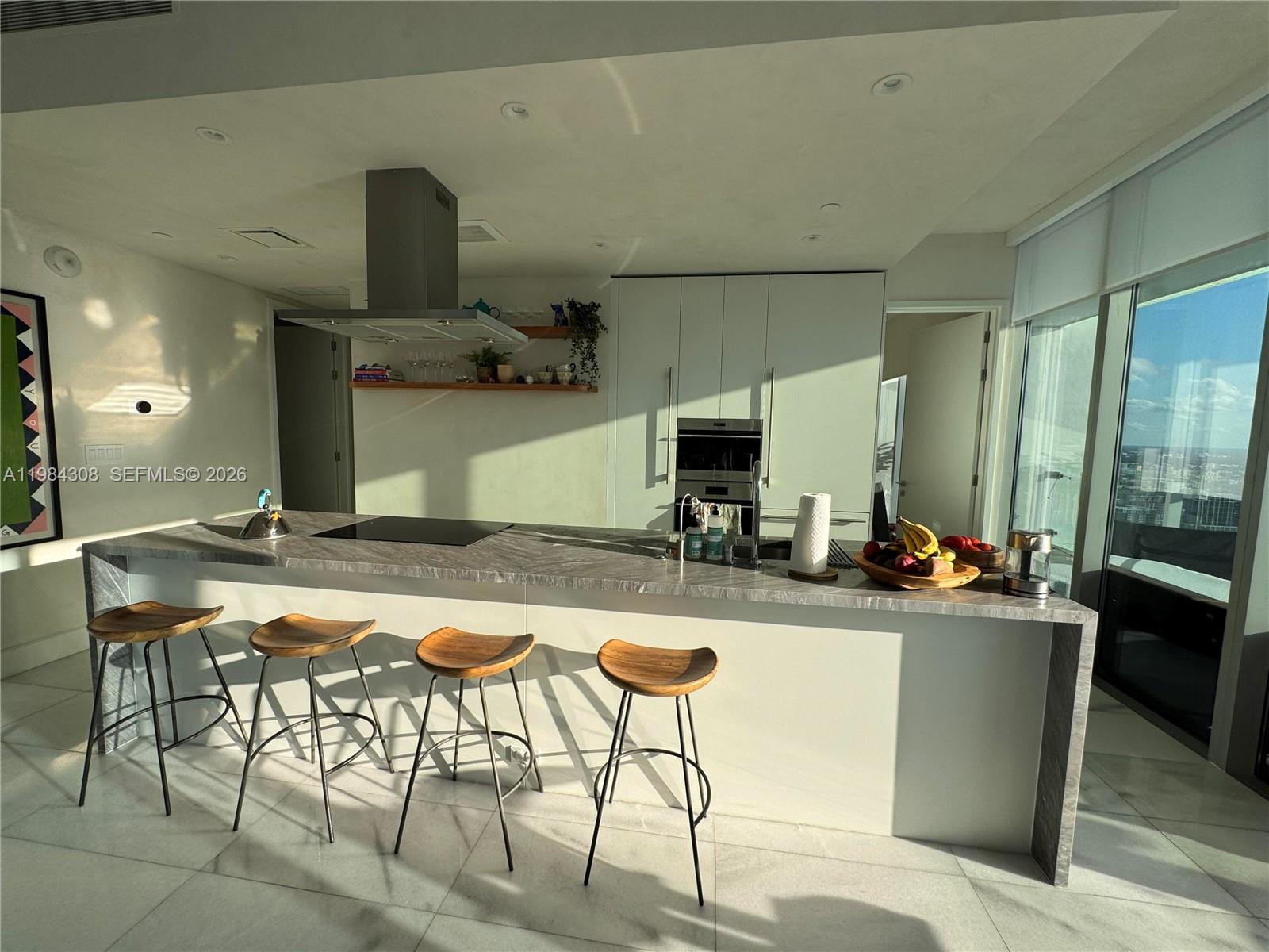 700 Northeast 26th Terrace, Unit 5006 Miami, FL 33137 - Photo 6 of 18 a kitchen with a table and chairs in it