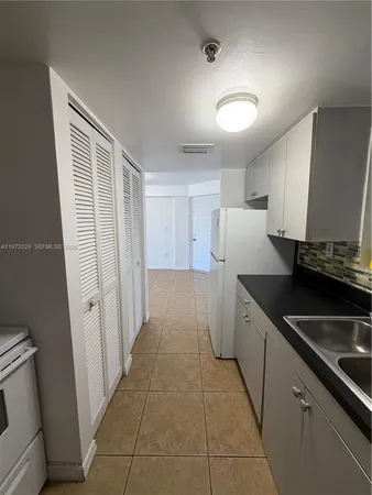 a kitchen with a sink and refrigerator