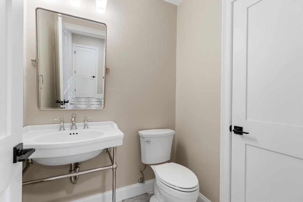 199 Nahant Street Wakefield, MA 01880 - Photo 18 of 39 a bathroom with a sink a toilet and a mirror
