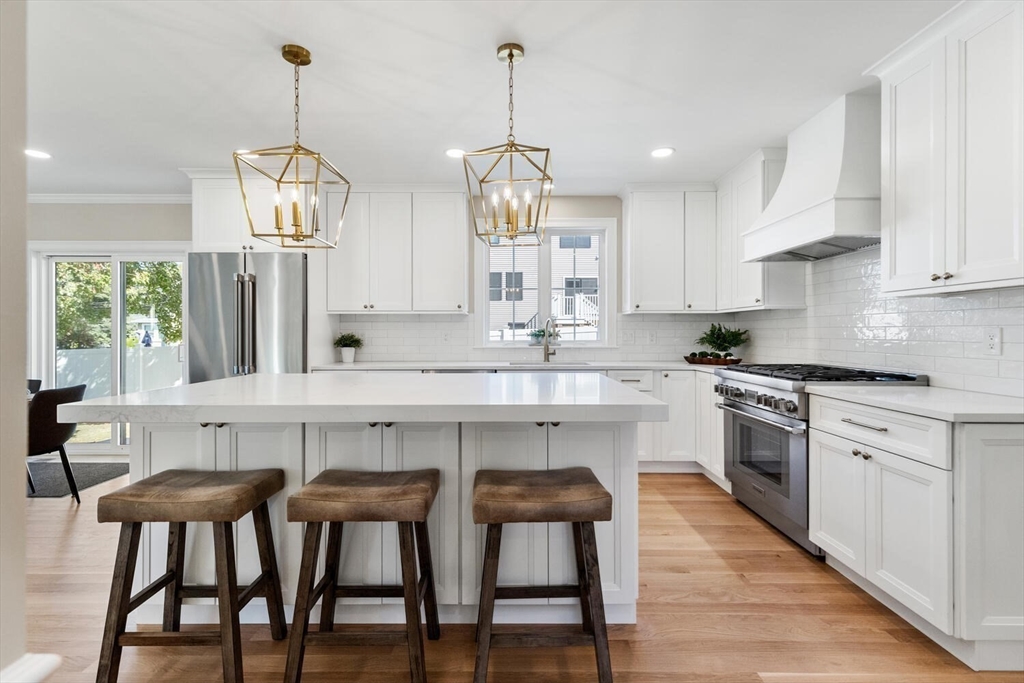 199 Nahant Street Wakefield, MA 01880 - Photo 3 of 39 a kitchen with stainless steel appliances granite countertop a stove a sink a center island and cabinets