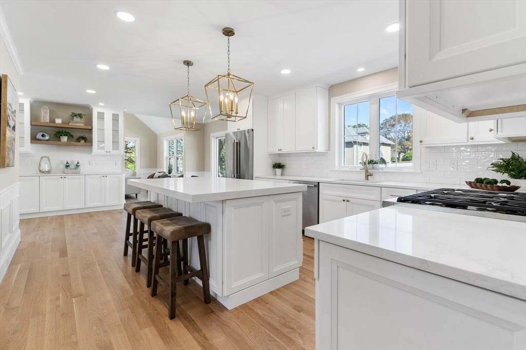 199 Nahant Street Wakefield, MA 01880 - Photo 5 of 39 a large kitchen with cabinets a sink a window and stainless steel appliances