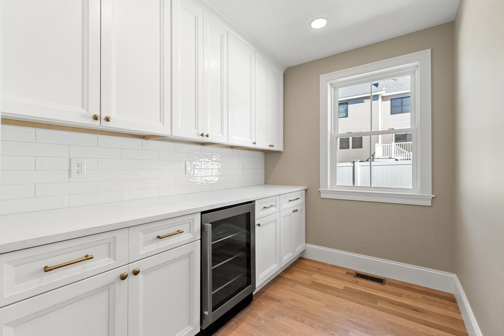 199 Nahant Street Wakefield, MA 01880 - Photo 7 of 39 a kitchen with granite countertop white cabinets and white appliances