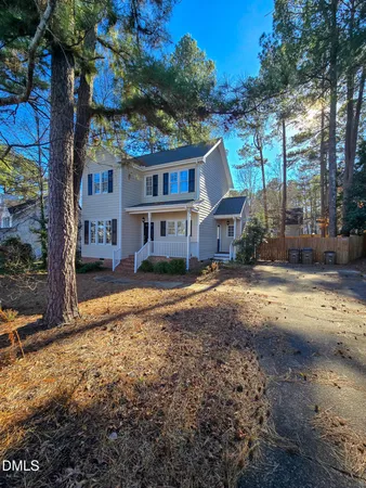 a house that has a tree in front of it