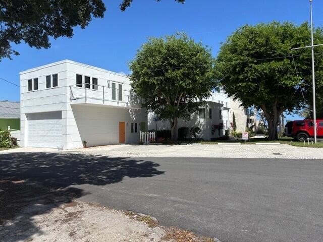 477 Southeast Riverside Drive Stuart, FL 34994 - Photo 7 of 7 a front view of a house with a yard