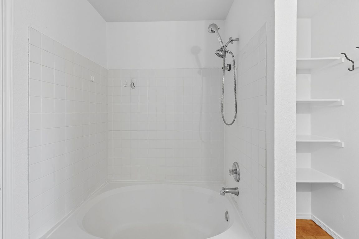 617 Riverway Lane Leander, TX 78641 - Photo 17 of 33 a bathroom with a glass shower door