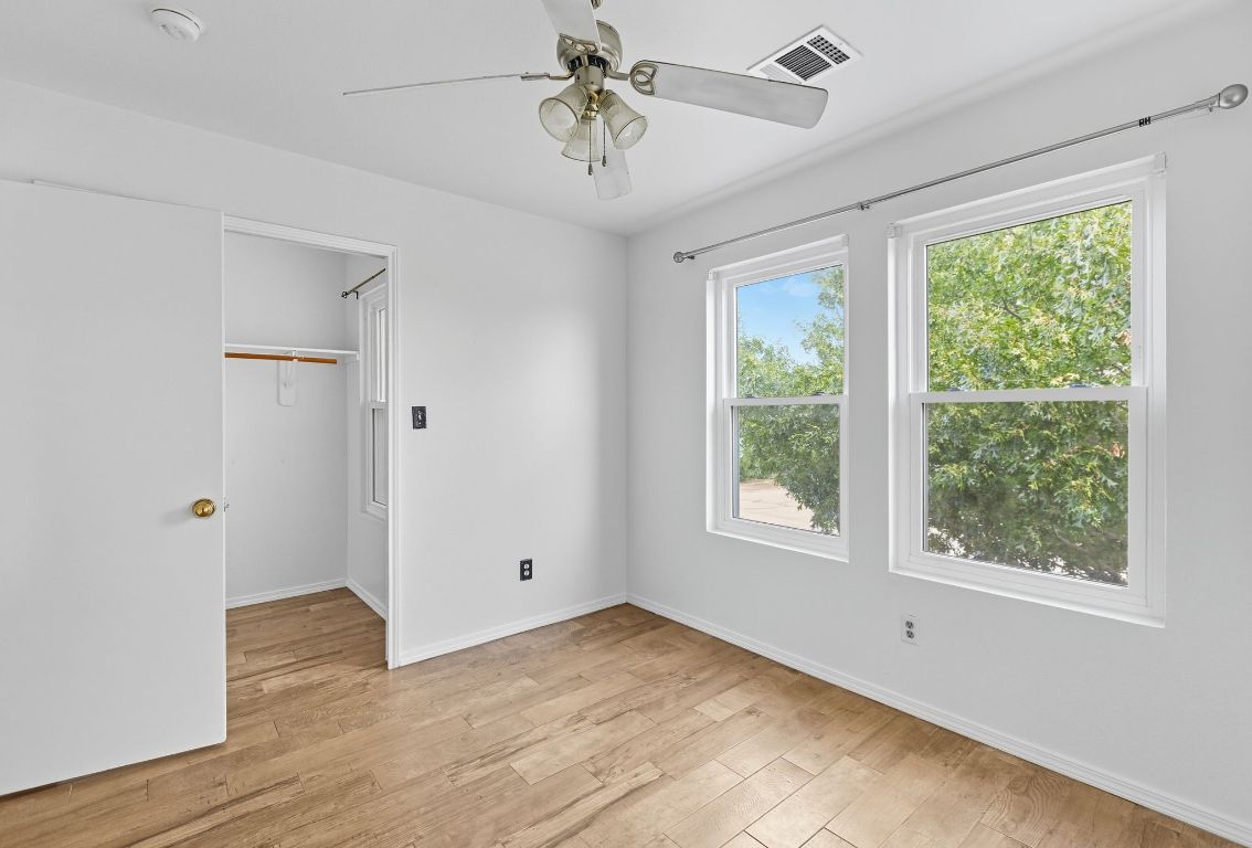 617 Riverway Lane Leander, TX 78641 - Photo 24 of 33 a view of an empty room with a window and wooden floor