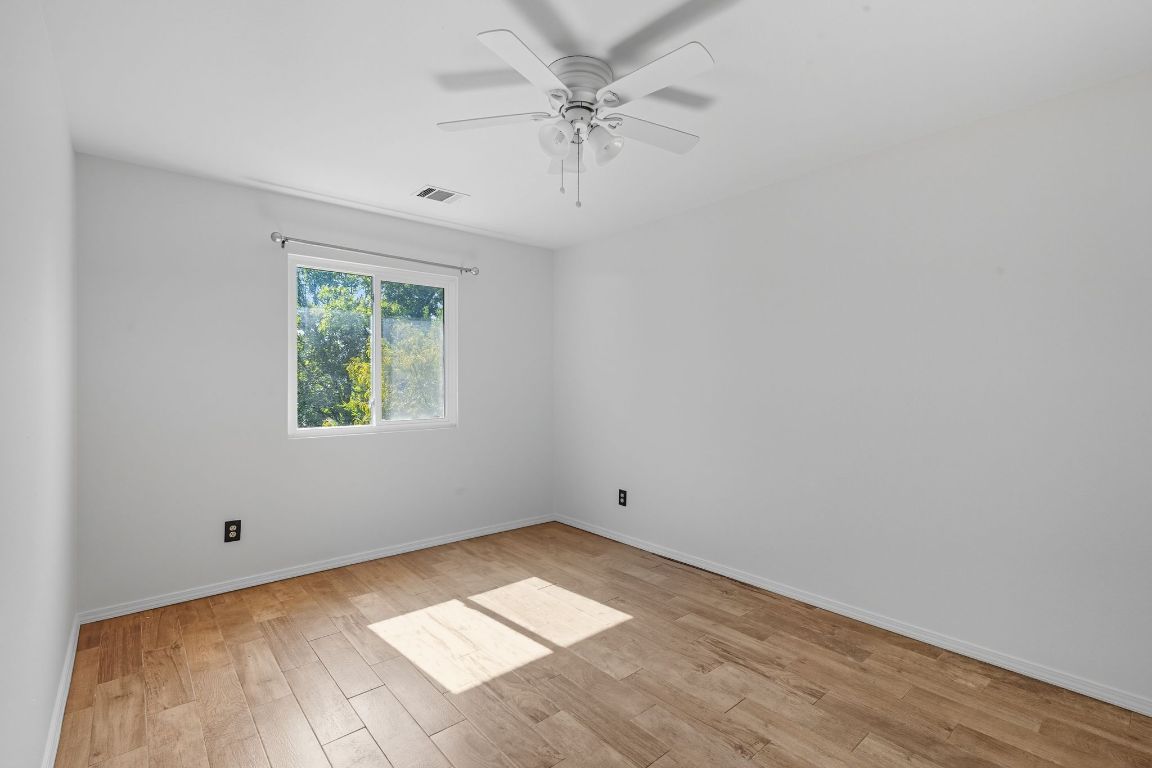 617 Riverway Lane Leander, TX 78641 - Photo 28 of 33 an empty room with a window and a ceiling fan