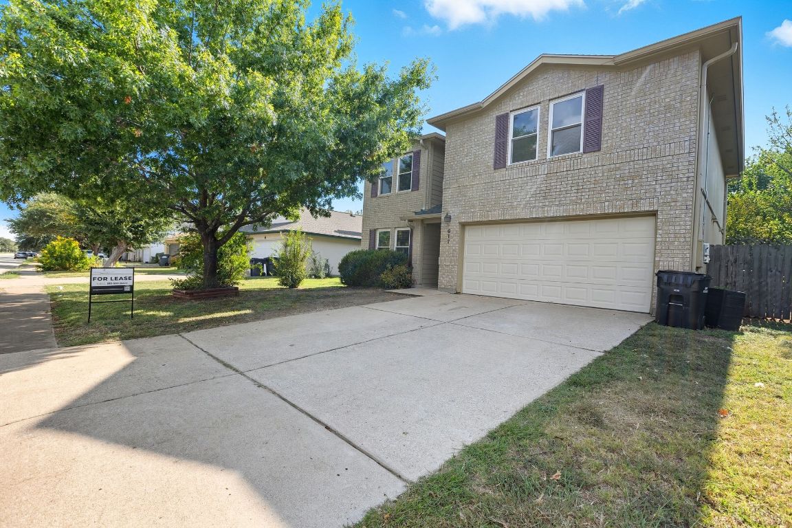 617 Riverway Lane Leander, TX 78641 - Photo 5 of 33 a front view of a house with a yard and garage