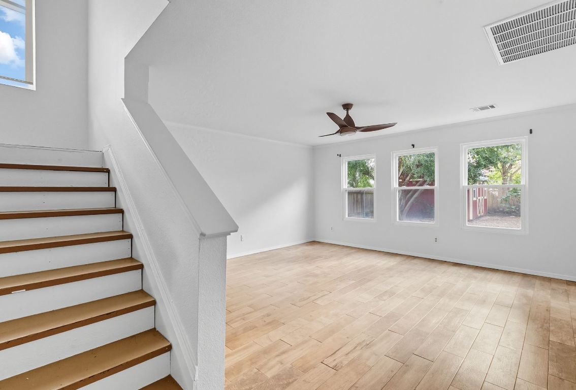 617 Riverway Lane Leander, TX 78641 - Photo 7 of 33 a view of an empty room with wooden floor and a window