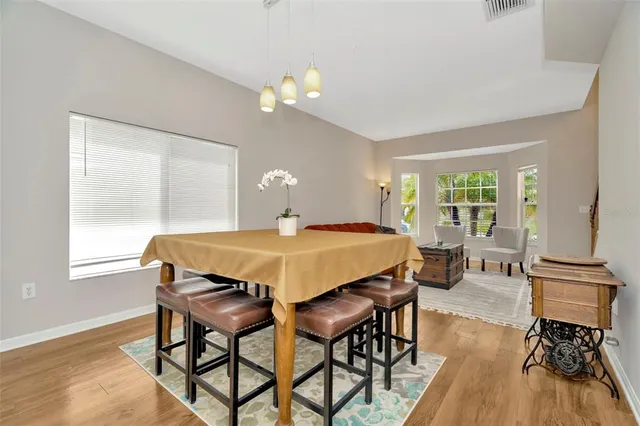 a dining room with wooden floor and breakfast area