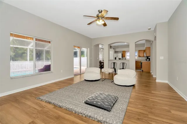 a living room with furniture and a wooden floor