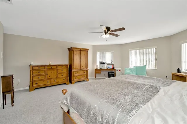 a bed room with a bed mirror and a window