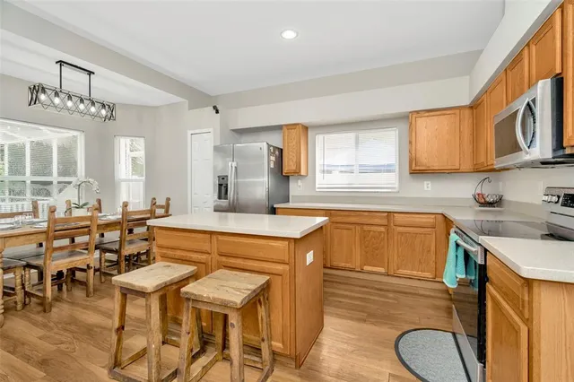 a kitchen with a table chairs sink and cabinets