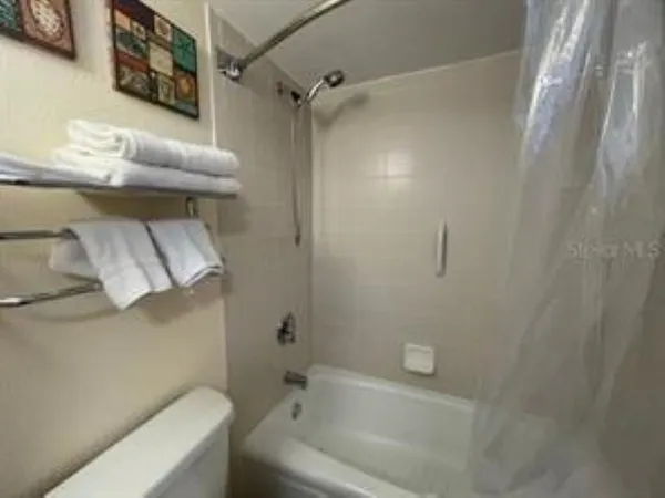 a bathroom with a toilet and a bathtub
