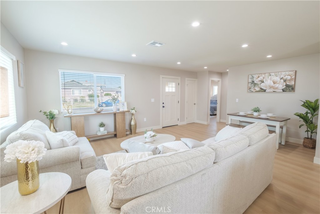 223 South Aprilia Avenue Compton, CA 90220 - Photo 5 of 46 a living room with furniture and a large window