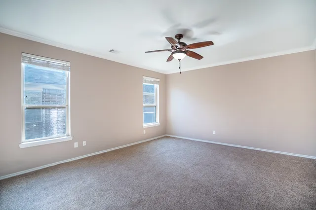 a view of room with a ceiling fan and window