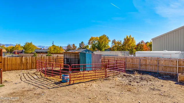 a view of a house with a wooden fence