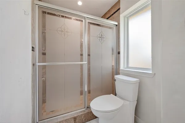a white toilet sitting next to a bathroom sink