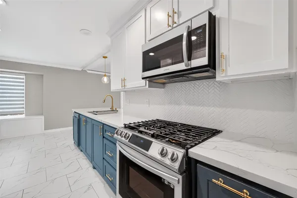 a kitchen with stainless steel appliances granite countertop a stove and a microwave