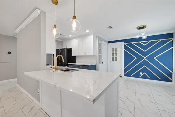 a kitchen with stainless steel appliances granite countertop a sink a stove and a refrigerator