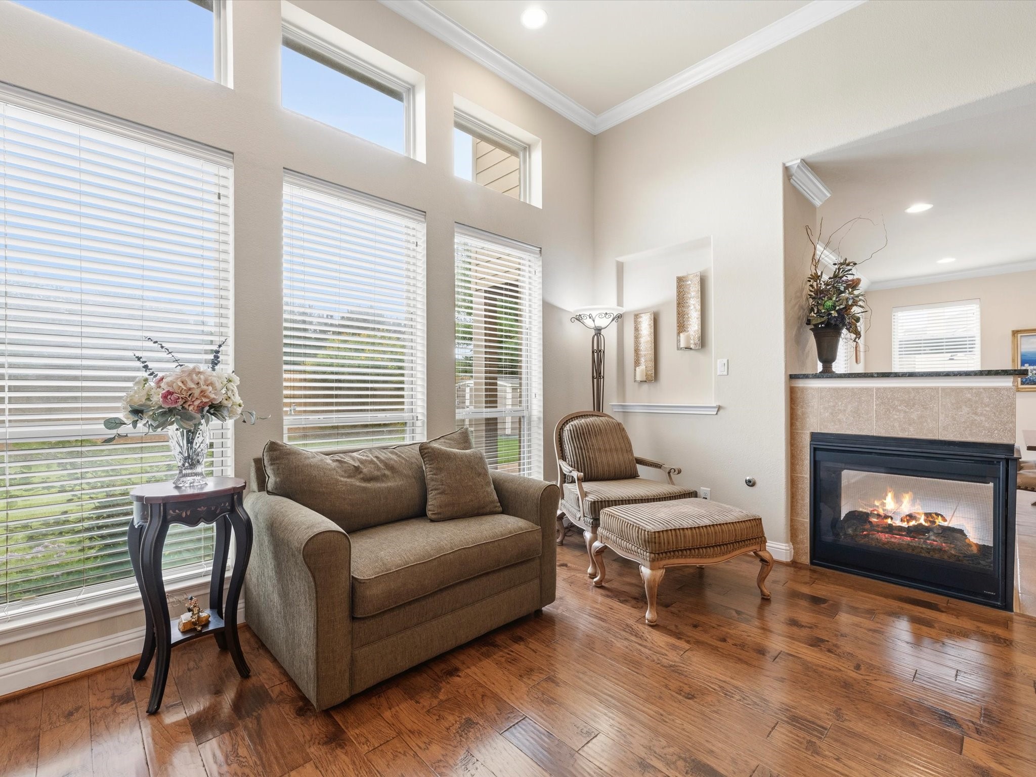3907 Randle Ridge Court Fulshear, TX 77441 - Photo 17 of 46 This inviting sitting area in the extended living space features large windows for ample natural light, and a stylish fireplace, all set on rich hardwood floors.