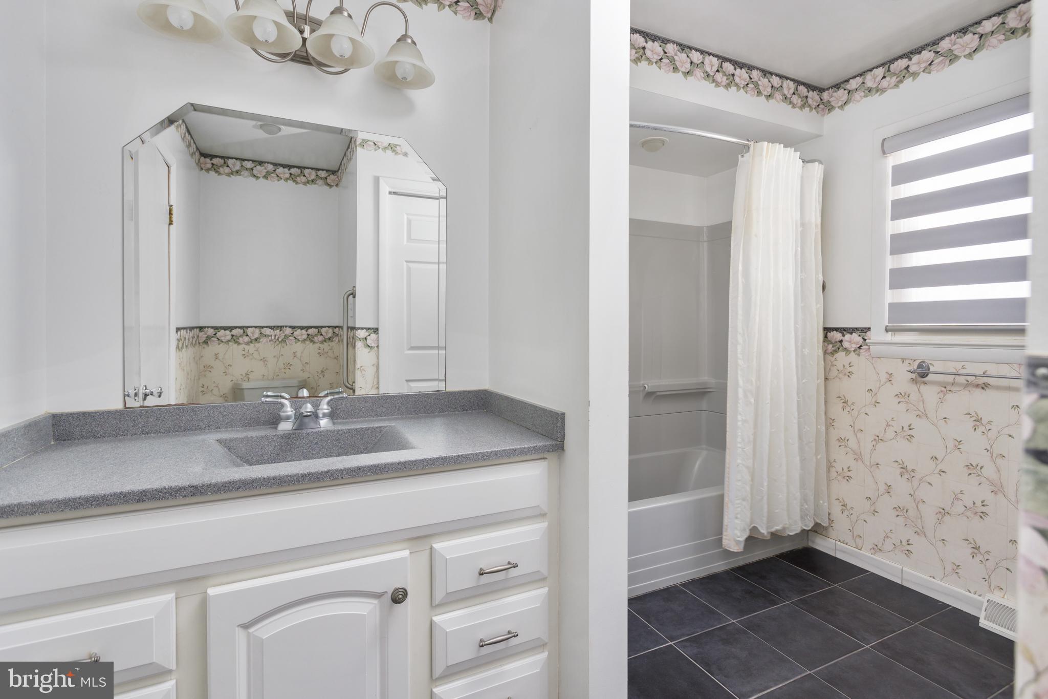 62 Tindall Road Robbinsville, NJ 08691 - Photo 12 of 21 a bathroom with a granite countertop sink a mirror and a shower