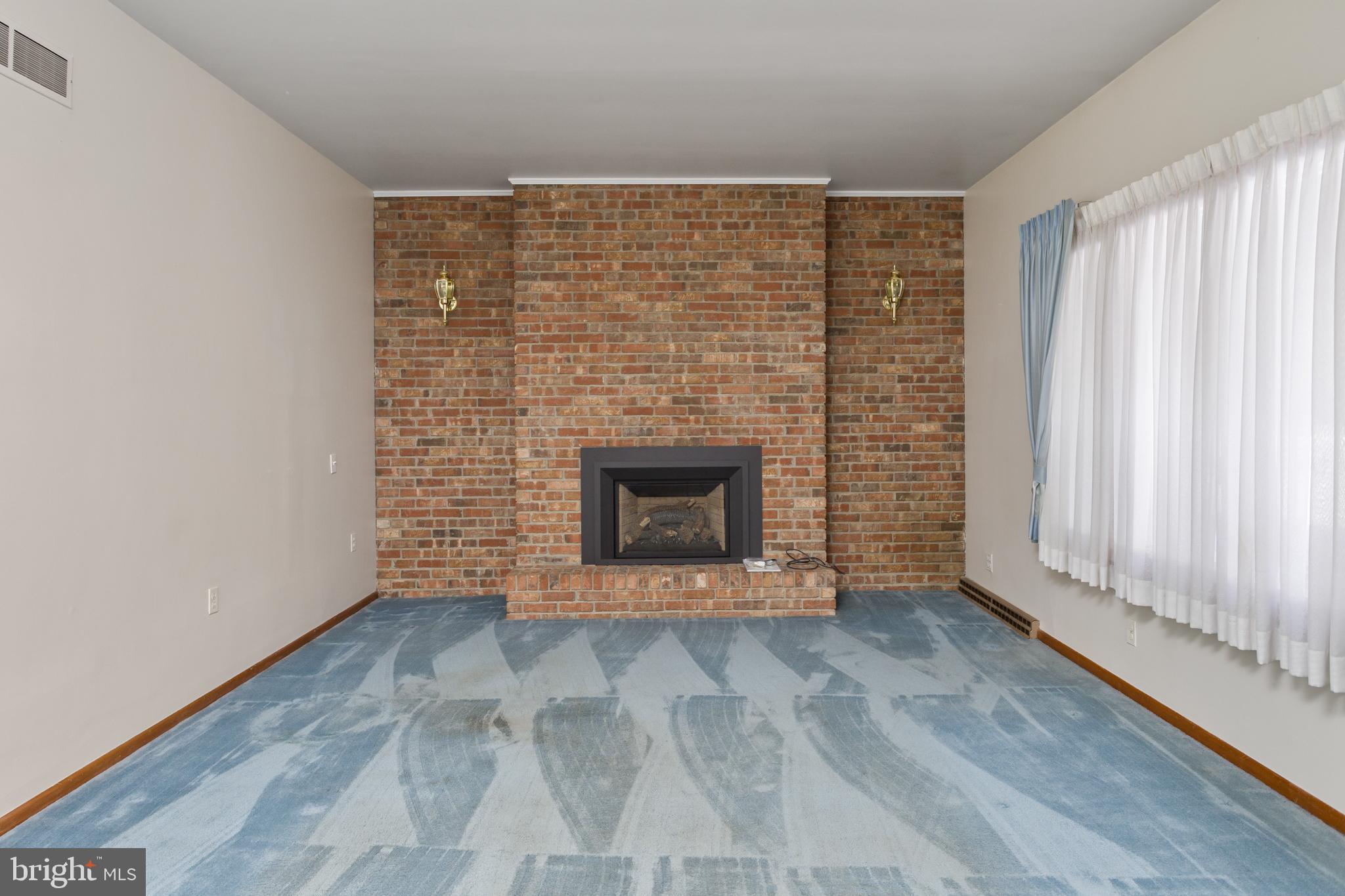 62 Tindall Road Robbinsville, NJ 08691 - Photo 8 of 21 a view of an empty room with a fireplace and a window