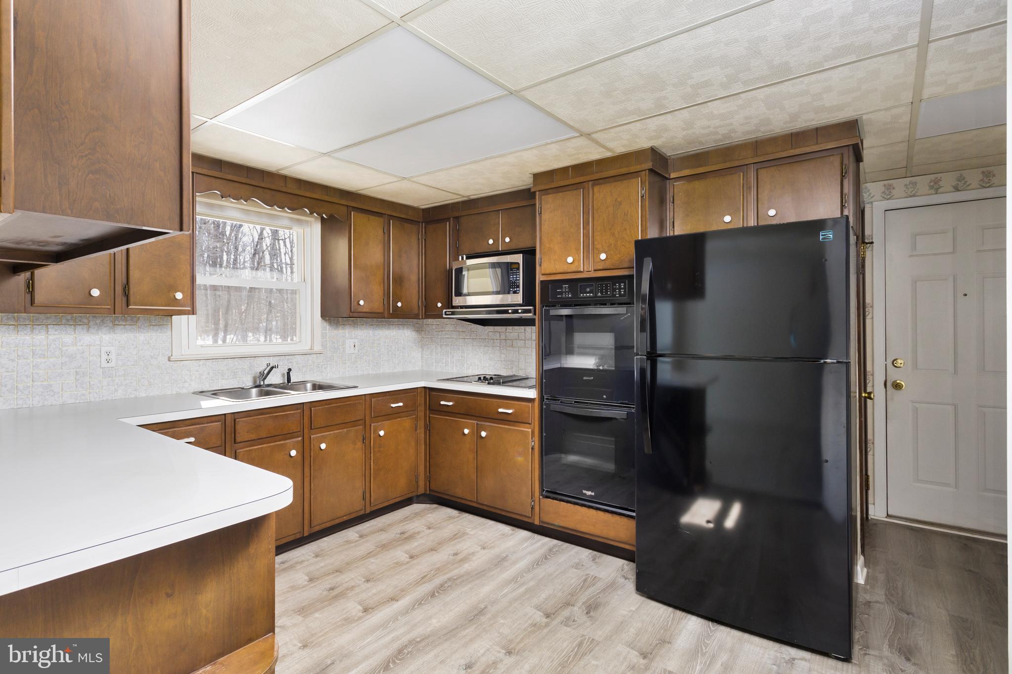 62 Tindall Road Robbinsville, NJ 08691 - Photo 10 of 21 a kitchen with a refrigerator and a sink