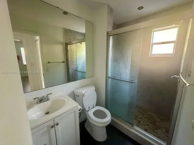 a bathroom with a toilet sink and shower