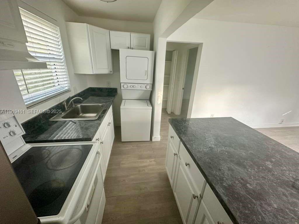 1150 Southwest 22nd Street, Unit 1 Miami, FL 33129 - Photo 4 of 13 a kitchen with granite countertop a sink stove and refrigerator