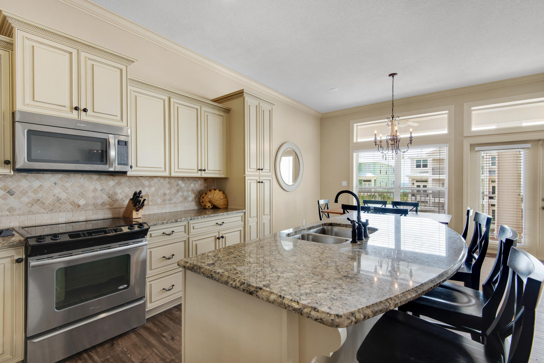 26 Nature Way, Unit 2004 Santa Rosa Beach, FL 32459 - Photo 11 of 65 a kitchen with kitchen island granite countertop a stove top oven a sink a dining table and chairs