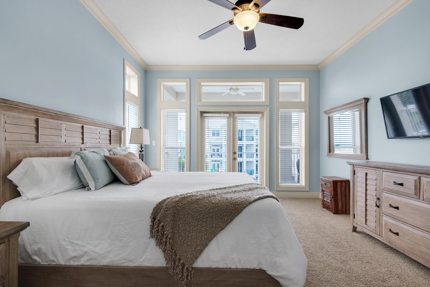 26 Nature Way, Unit 2004 Santa Rosa Beach, FL 32459 - Photo 15 of 65 a bedroom with a large bed and a chandelier