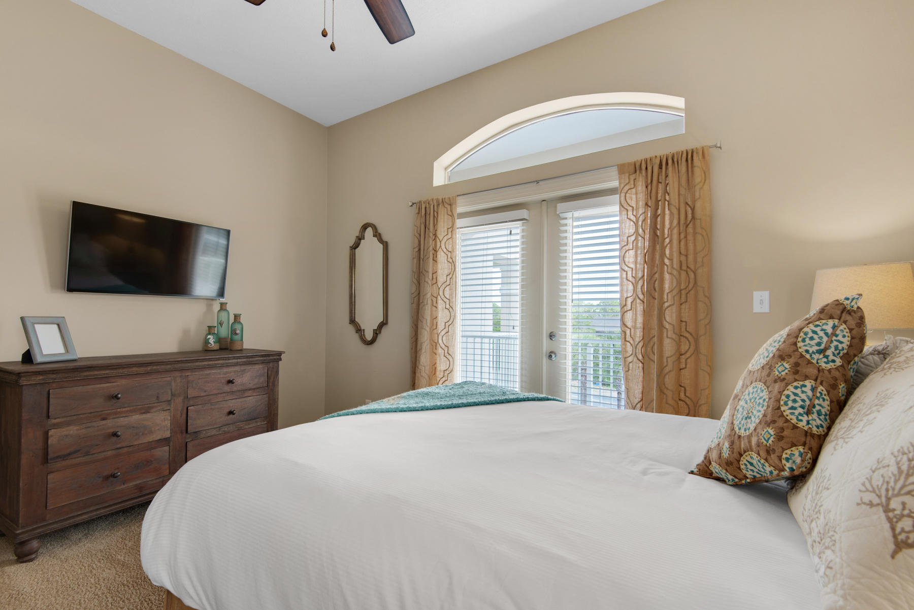 26 Nature Way, Unit 2004 Santa Rosa Beach, FL 32459 - Photo 26 of 65 a bedroom with a large bed and a flat tv screen on dresser