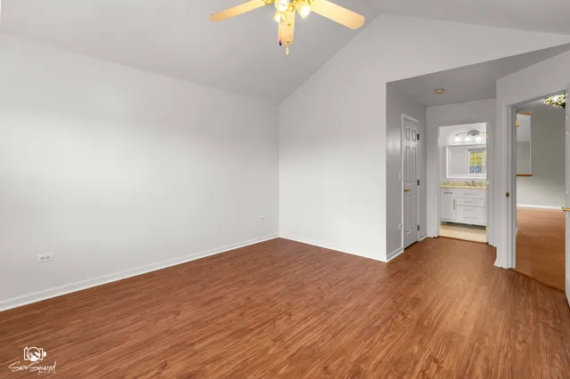 a view of empty room with wooden floor