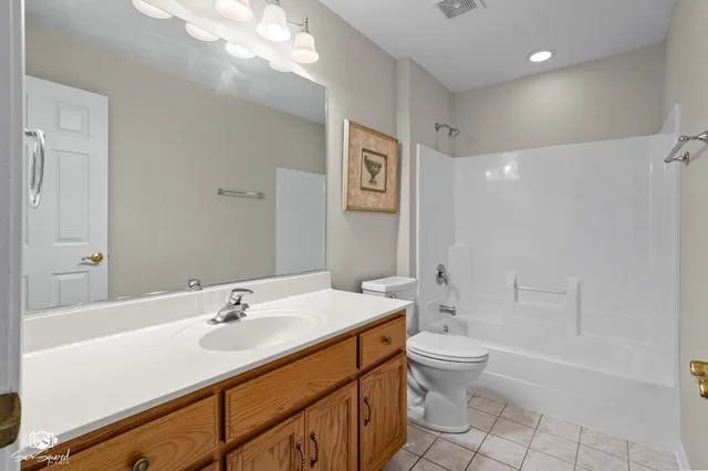 a bathroom with a sink a toilet and a large mirror