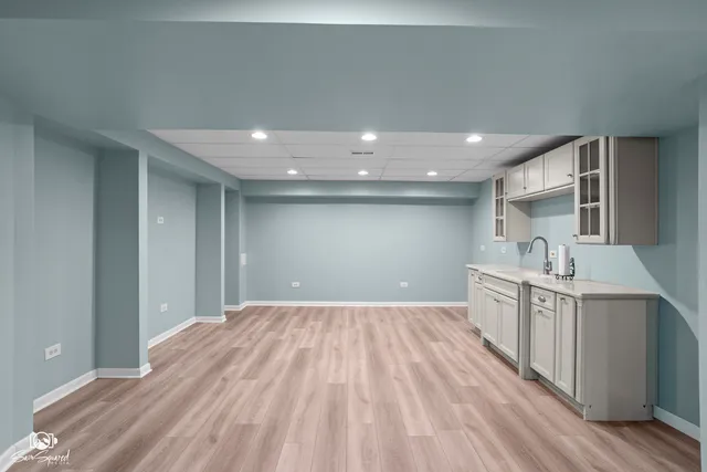 a open kitchen with kitchen island a sink appliances and cabinets