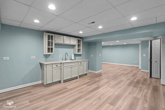a large kitchen with stainless steel appliances granite countertop a sink and cabinets