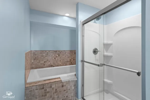 a bathroom with a bathtub and a shower