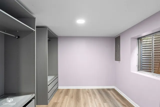 a view of a room with wooden floor and a window