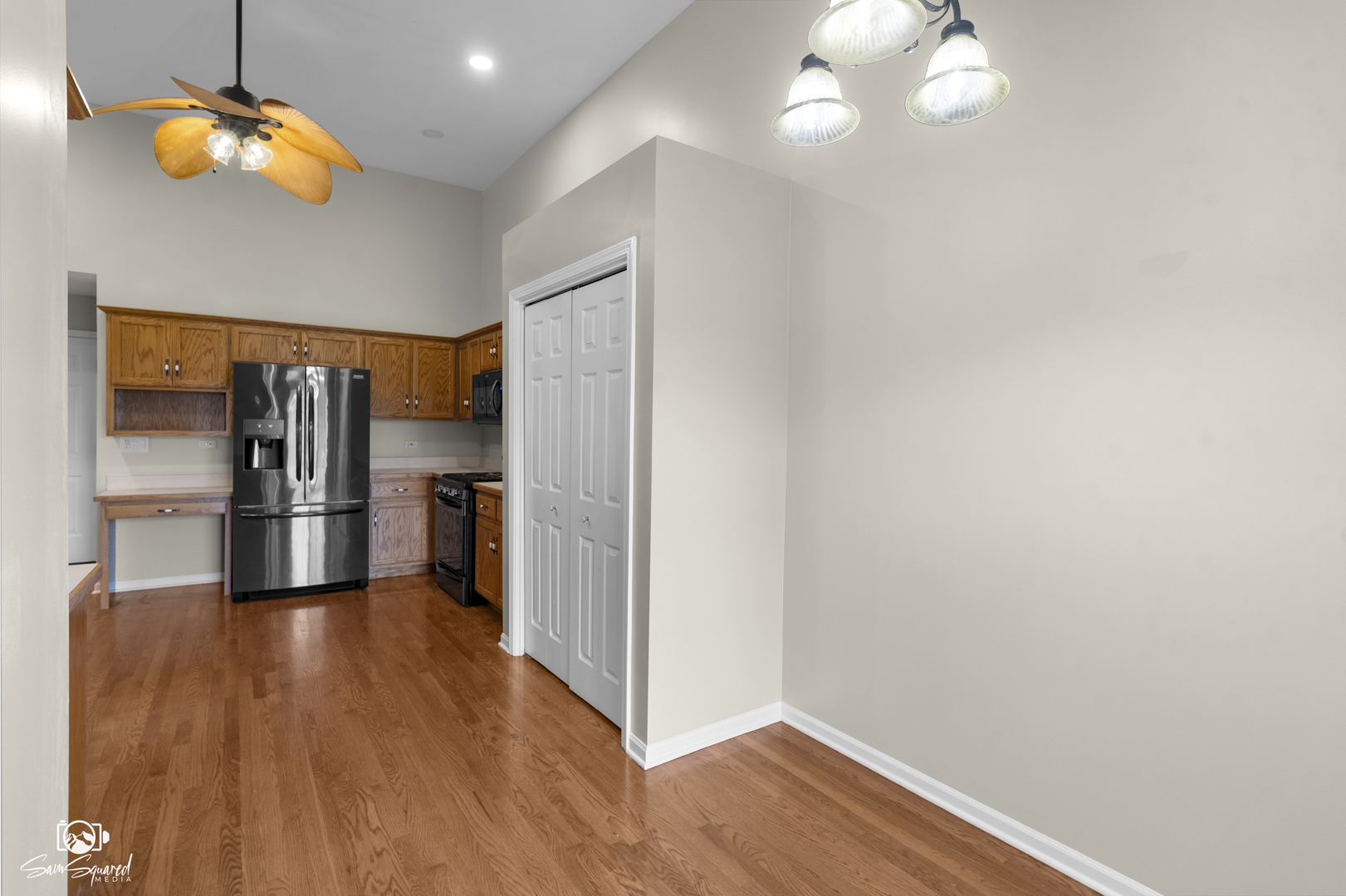 1431 Coral Bell Drive Joliet, IL 60435 - Photo 9 of 38 a view of a kitchen with a refrigerator a ceiling fan and wooden floor