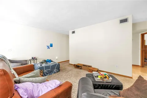 a living room with furniture and a book shelf