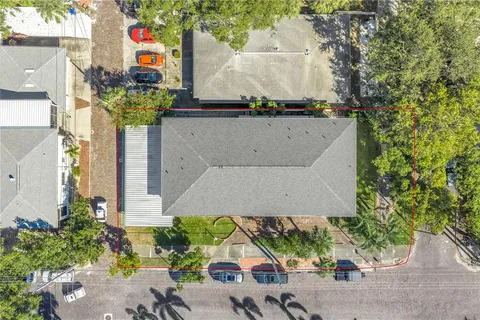 a view of a house with a yard and potted plants