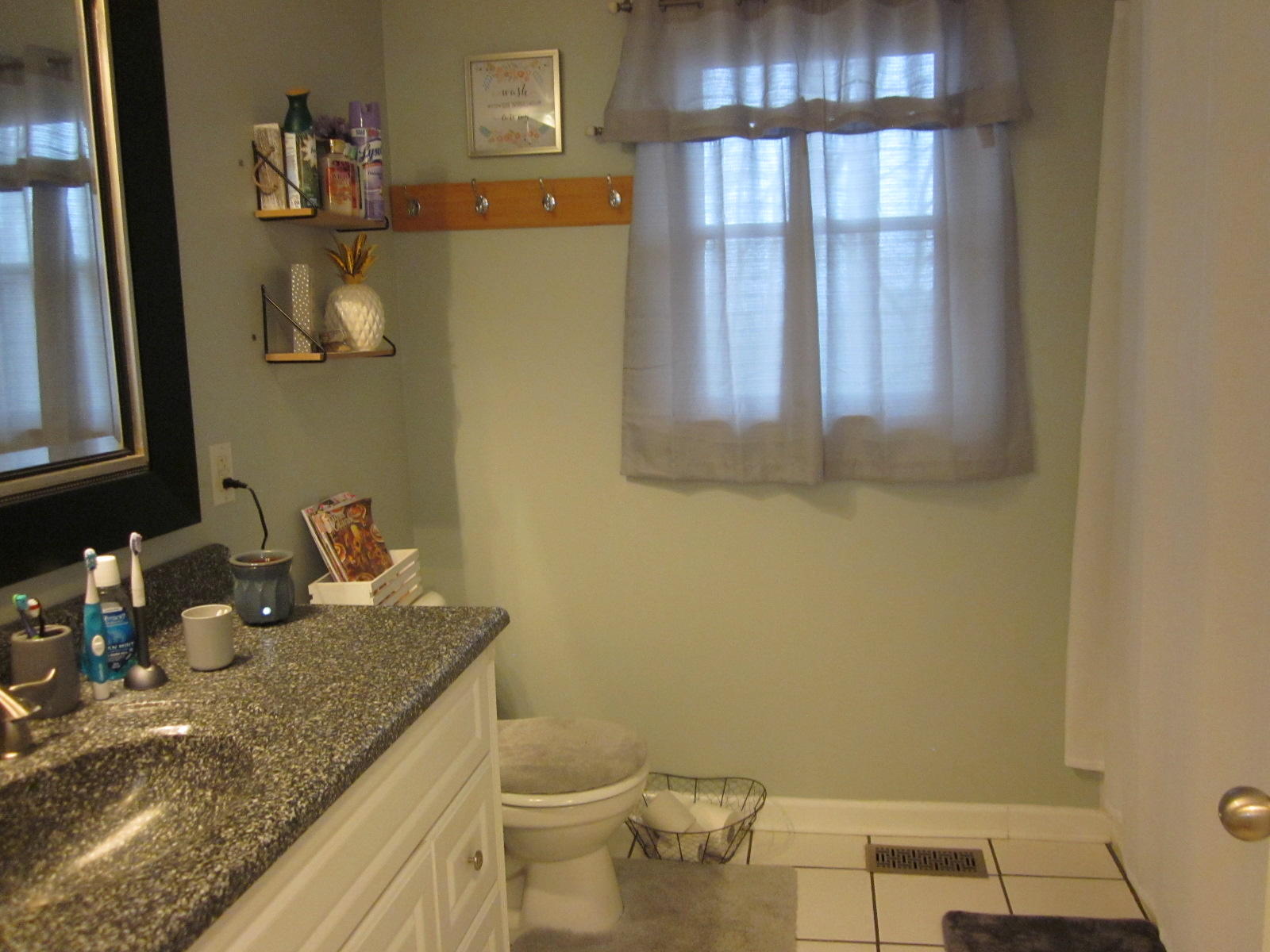 77 Pony Ridge Road Bassett, VA 24055 - Photo 37 of 84 a bathroom with a granite countertop sink and a mirror