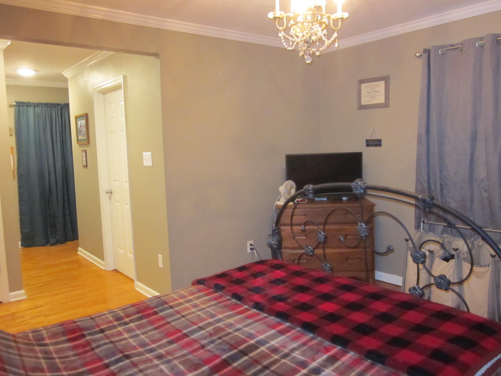 77 Pony Ridge Road Bassett, VA 24055 - Photo 44 of 84 a bedroom with a bed and a chandelier