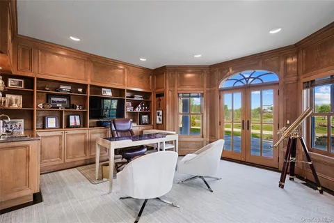 a living room with furniture a rug and a book shelf