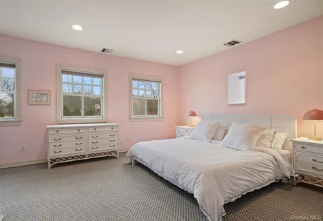 a bedroom with two beds and a window