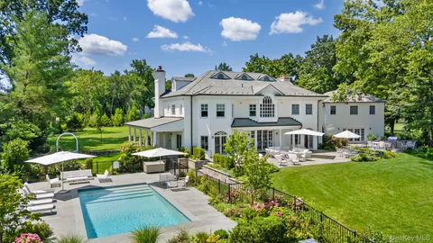 a front view of a house with garden and porch
